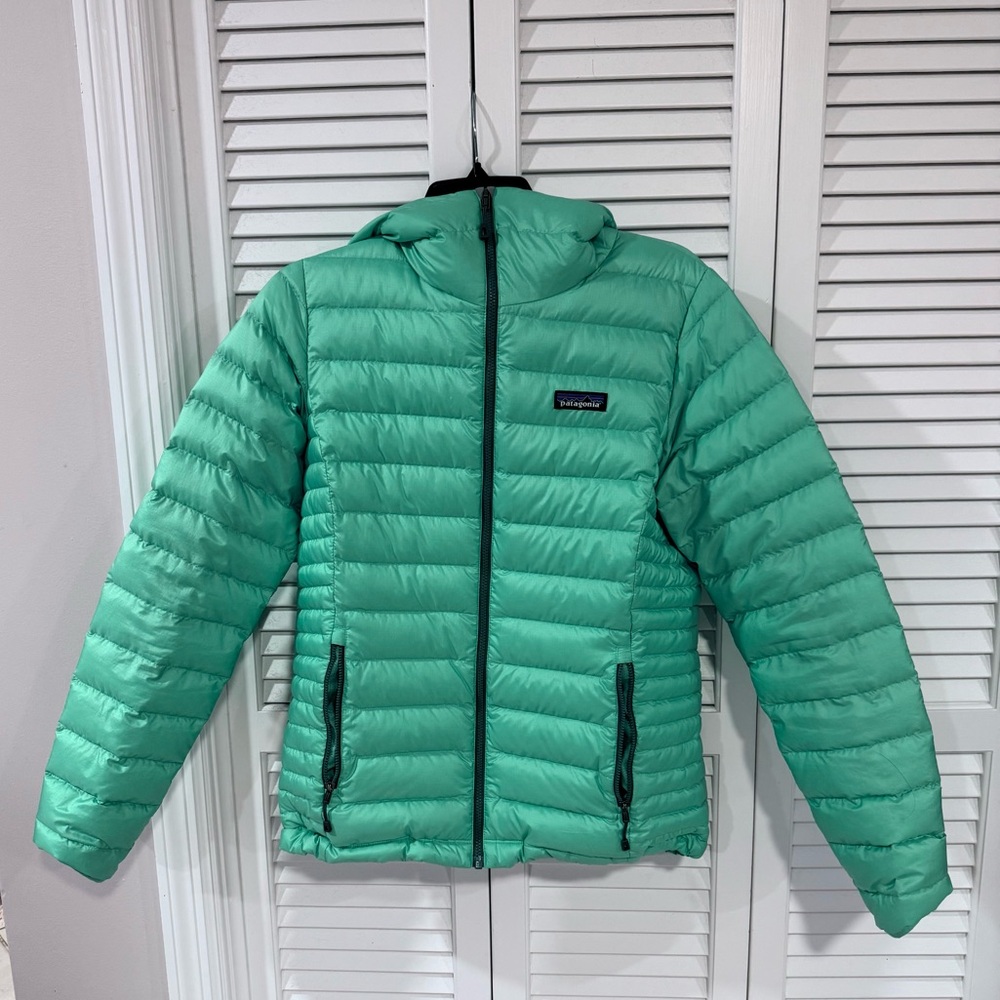 Patagonia Women’s Down Sweater Hoody in a bright teal green.
